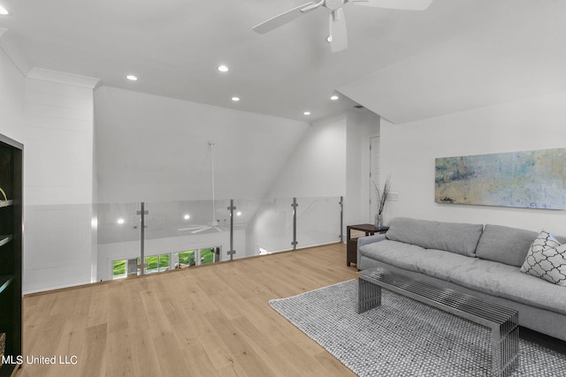 living room with ceiling fan, lofted ceiling, and light hardwood / wood-style flooring