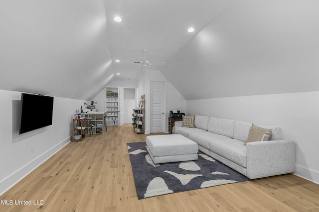 living room featuring light hardwood / wood-style floors, vaulted ceiling, and ceiling fan