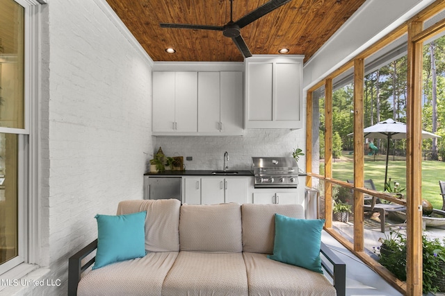 kitchen with backsplash, white cabinetry, wooden ceiling, and sink