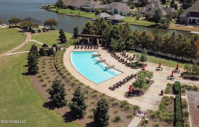 view of pool with a lawn and a water view