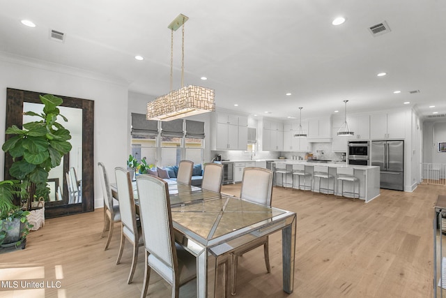 dining area featuring wine cooler, light hardwood / wood-style flooring, and ornamental molding