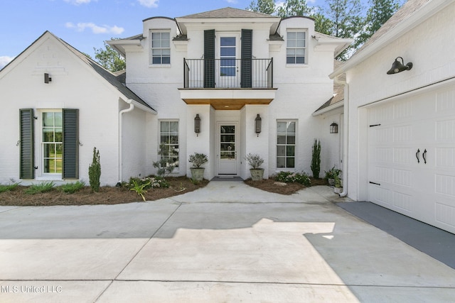 view of front of property with a garage and a balcony