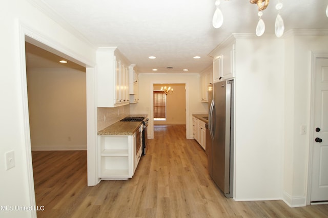 kitchen featuring stainless steel appliances, light wood-type flooring, backsplash, white cabinetry, and ornamental molding