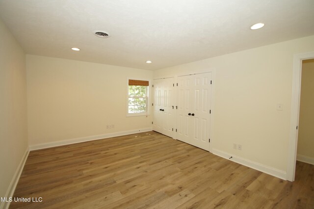 unfurnished bedroom featuring hardwood / wood-style flooring