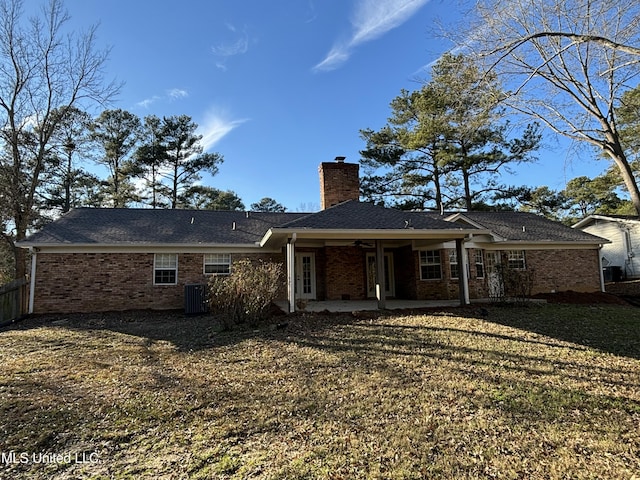 4620 W Cheryl Dr, Jackson, MS 39211 - back of property with central air condition unit, a patio area, and a lawn