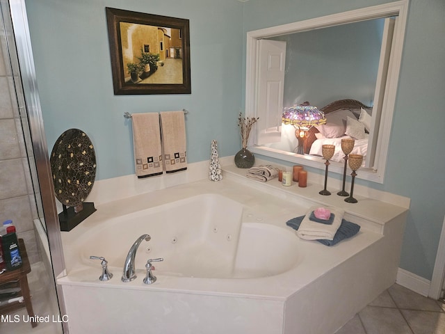 bathroom with tile patterned flooring and a tub