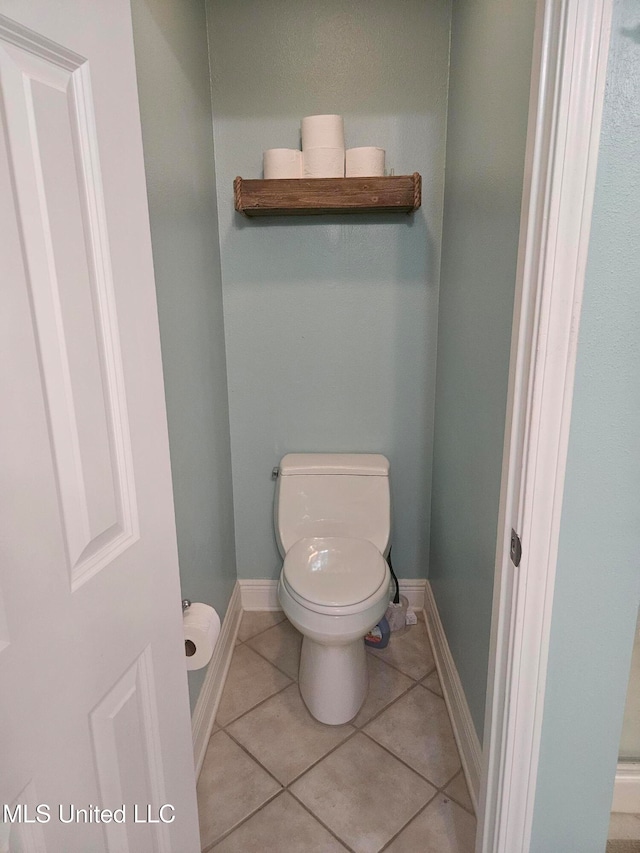 bathroom with tile patterned flooring and toilet