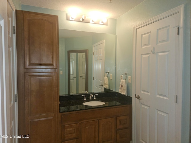 bathroom with vanity and a textured ceiling