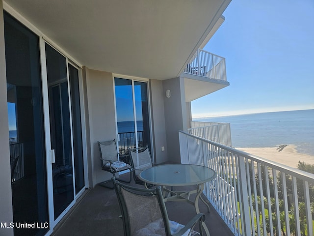 balcony featuring a water view and a view of the beach