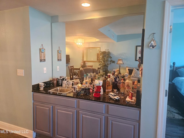 bathroom featuring hardwood / wood-style flooring, vanity, and a notable chandelier