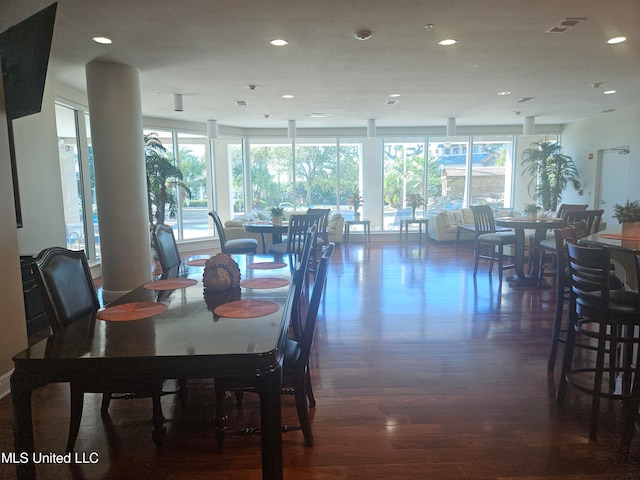 dining area with plenty of natural light and dark hardwood / wood-style flooring