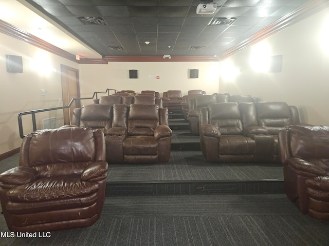 home theater room featuring dark carpet and ornamental molding