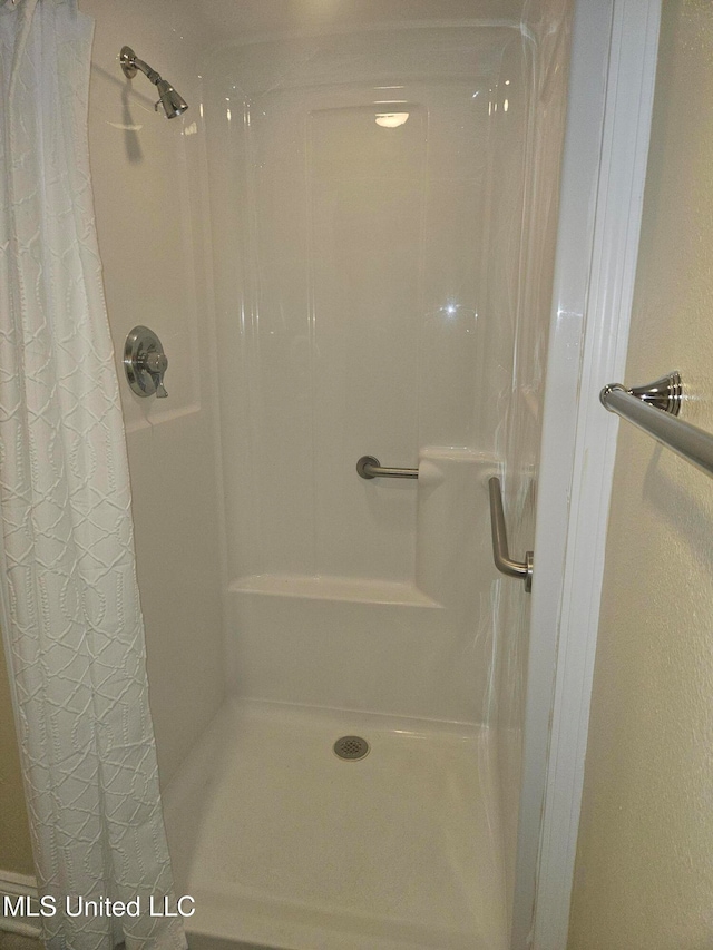 bathroom with a shower with shower curtain