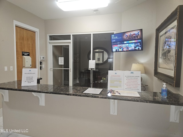 2668 Beach Blvd Unit 702, Biloxi, MS 39531 - kitchen with dark stone counters and a breakfast bar area