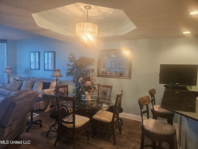 2668 Beach Blvd Unit 702, Biloxi, MS 39531 - dining room featuring wood finished floors, baseboards, a chandelier, a tray ceiling, and a textured ceiling