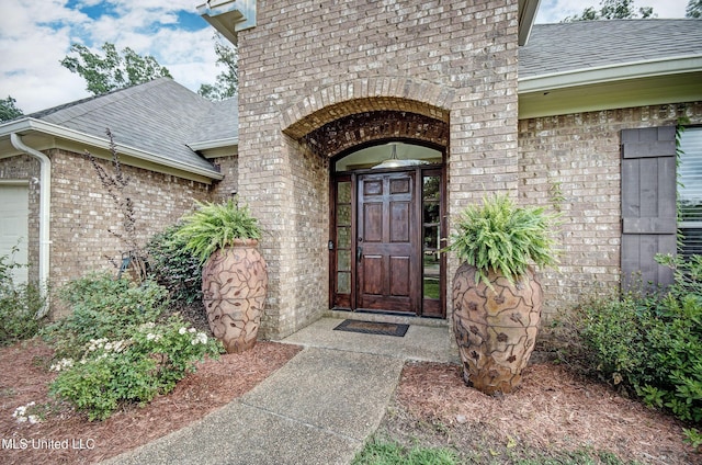 127 Rockbridge Cir, Clinton, MS 39056 - property entrance with brick siding, a shingled roof, and an attached garage