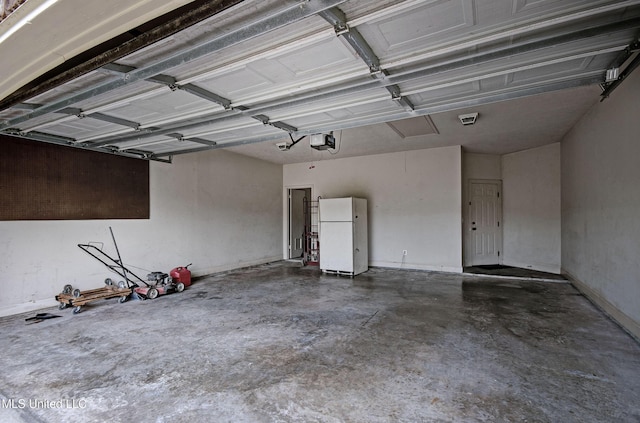 127 Rockbridge Cir, Clinton, MS 39056 - garage with freestanding refrigerator and a garage door opener