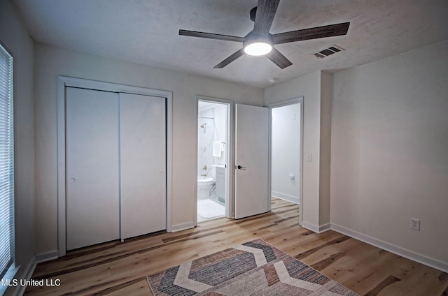226 N Shenandoah Rd, Brandon, MS 39047 - unfurnished bedroom with light wood-style flooring, a closet, a ceiling fan, a textured ceiling, and ensuite bathroom