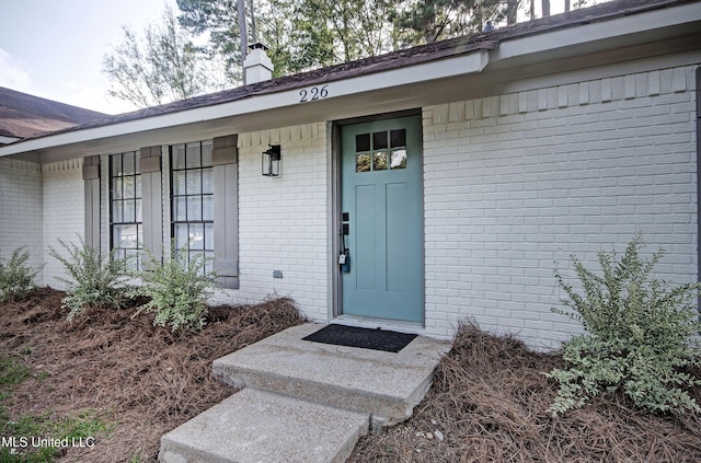 226 N Shenandoah Rd, Brandon, MS 39047 - view of exterior entry with brick siding and a chimney