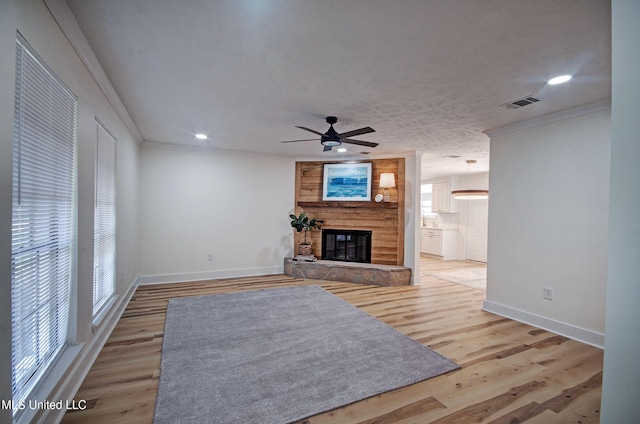 226 N Shenandoah Rd, Brandon, MS 39047 - unfurnished living room with crown molding, a fireplace, ceiling fan, light wood-type flooring, and recessed lighting