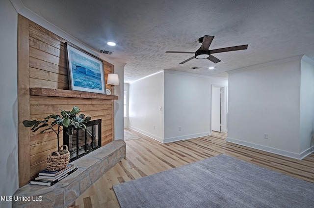 226 N Shenandoah Rd, Brandon, MS 39047 - living room with wood finished floors, ornamental molding, a ceiling fan, a glass covered fireplace, and recessed lighting