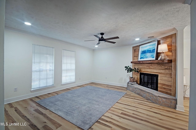226 N Shenandoah Rd, Brandon, MS 39047 - unfurnished living room with a large fireplace, wood finished floors, ornamental molding, ceiling fan, and recessed lighting