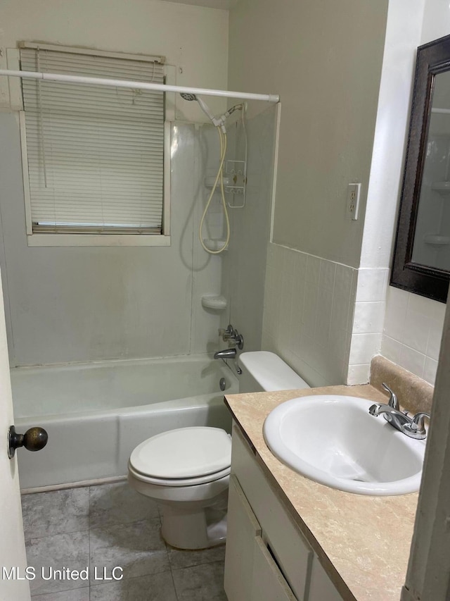 bathroom featuring toilet, washtub / shower combination, and vanity