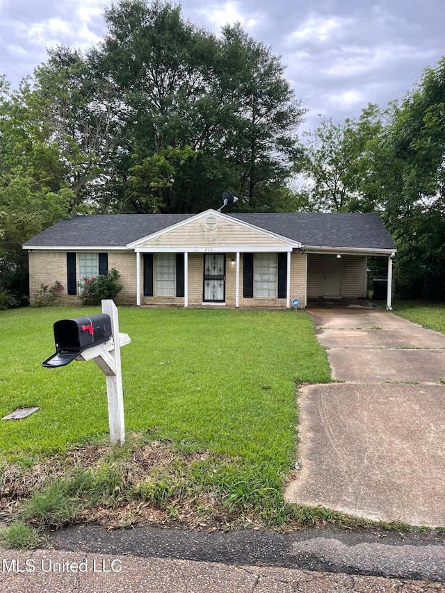 ranch-style house with driveway, a carport, and a front lawn