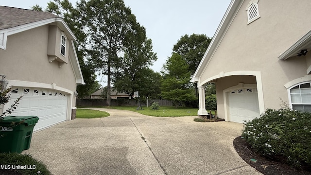 17000 River Pl, Vancleave, MS 39565 - view of side of home with driveway, stucco siding, a garage, and roof with shingles