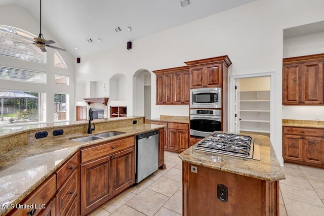 17000 River Pl, Vancleave, MS 39565 - kitchen featuring stainless steel appliances, light tile patterned floors, a sink, ceiling fan, and a kitchen island