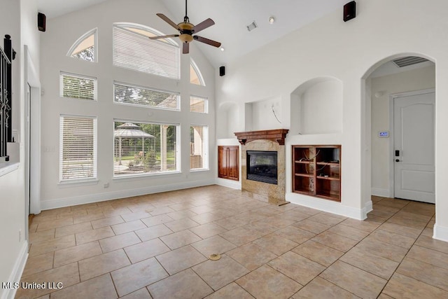 17000 River Pl, Vancleave, MS 39565 - unfurnished living room with a ceiling fan, built in features, a fireplace, high vaulted ceiling, and light tile patterned floors
