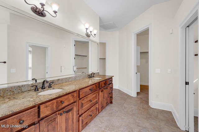 17000 River Pl, Vancleave, MS 39565 - bathroom with a chandelier, a walk in closet, and double vanity