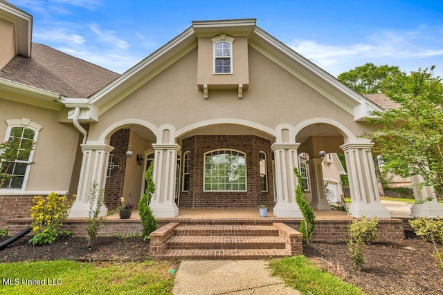 17000 River Pl, Vancleave, MS 39565 - doorway to property with covered porch, stucco siding, and brick siding
