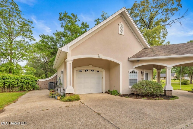 17000 River Pl, Vancleave, MS 39565 - view of front facade with driveway, a garage, stucco siding, central AC, and roof with shingles