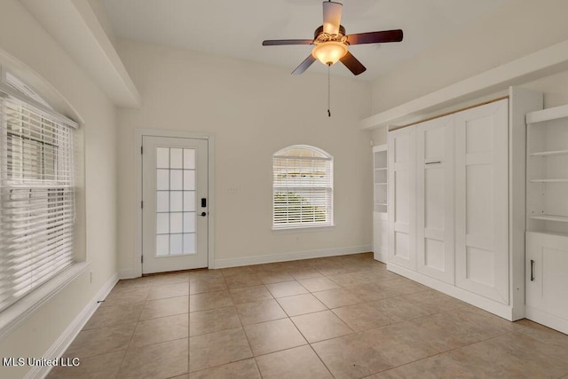 17000 River Pl, Vancleave, MS 39565 - unfurnished bedroom featuring light tile patterned floors, ceiling fan, and baseboards