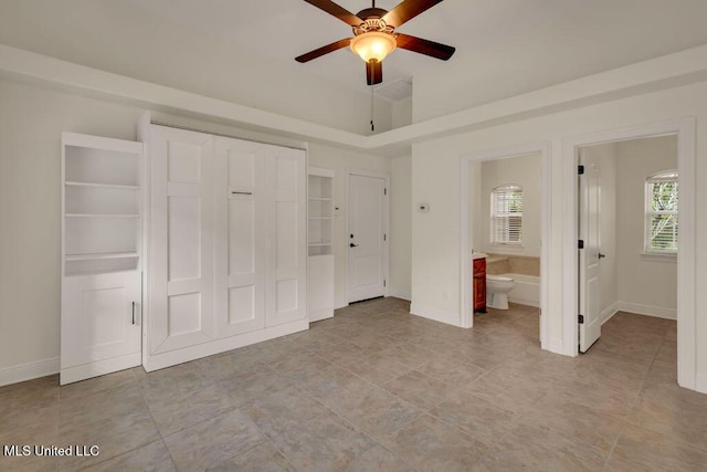 17000 River Pl, Vancleave, MS 39565 - unfurnished bedroom featuring baseboards, a closet, ensuite bath, and a ceiling fan