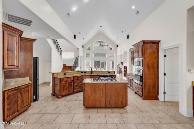 17000 River Pl, Vancleave, MS 39565 - kitchen featuring stainless steel appliances, a large island, a ceiling fan, a sink, and light tile patterned floors