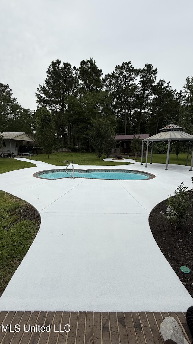 17000 River Pl, Vancleave, MS 39565 - outdoor pool with a gazebo, a lawn, a patio, and view of wooded area