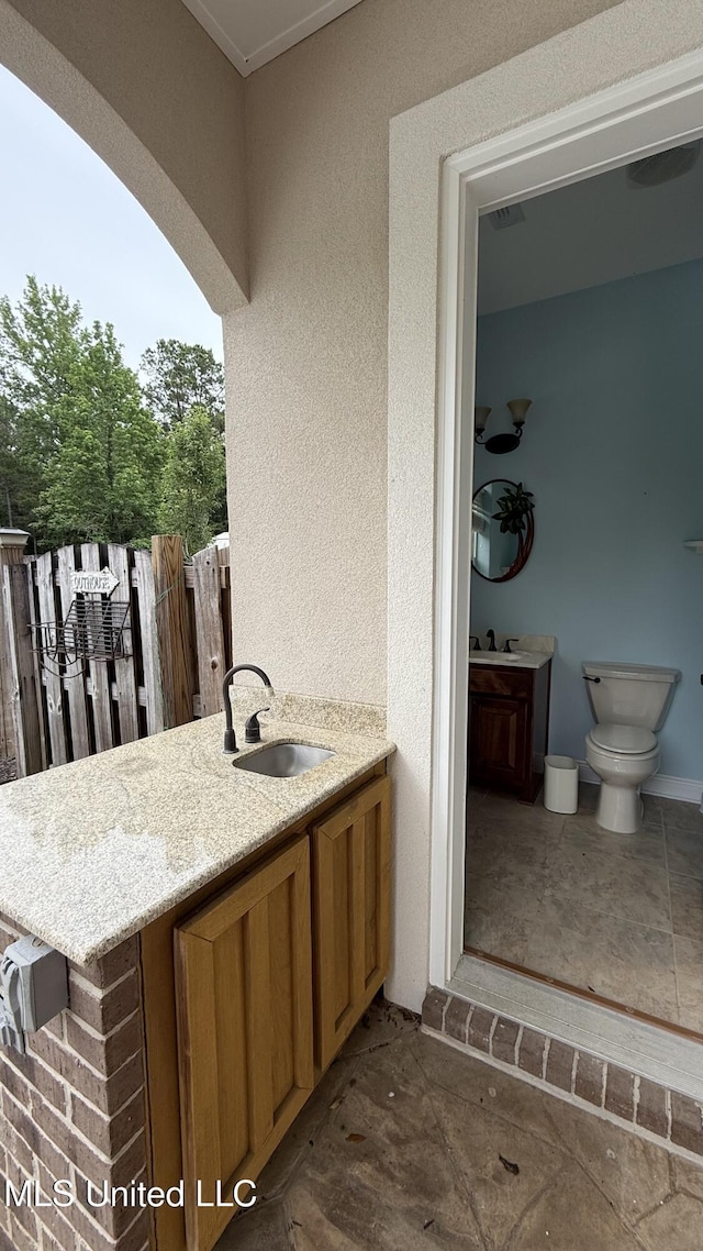 17000 River Pl, Vancleave, MS 39565 - bathroom with vanity, toilet, and a textured wall