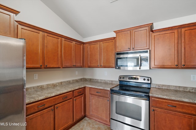 kitchen with stainless steel appliances and vaulted ceiling