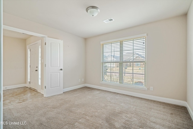 unfurnished room featuring light colored carpet