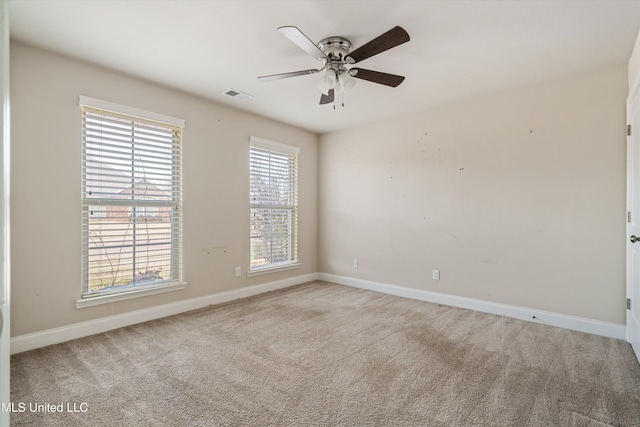 carpeted spare room with ceiling fan and a healthy amount of sunlight