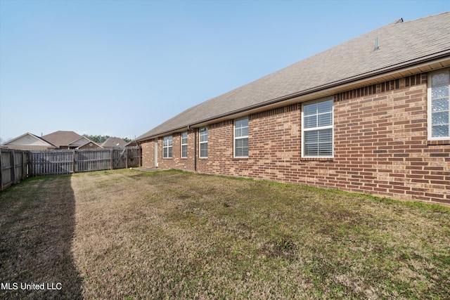 back of house with a yard