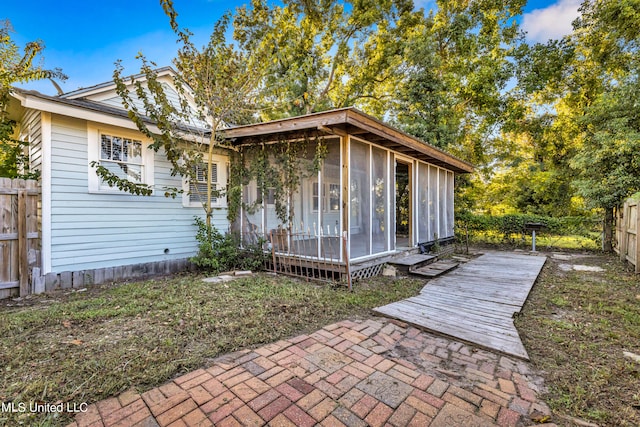 view of front of property with a patio and a sunroom