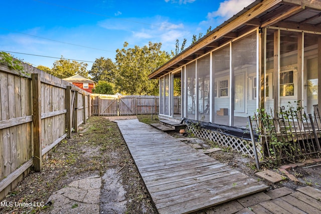 wooden terrace featuring a sunroom