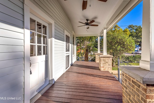 wooden deck with covered porch and ceiling fan