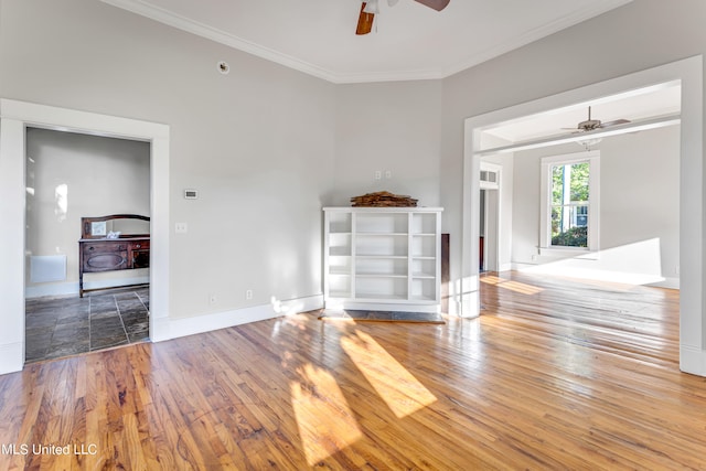 empty room with crown molding, wood-type flooring, and ceiling fan