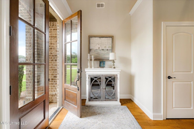 8063 Elizabeth Dr, Olive Branch, MS 38654 - doorway with baseboards, wood finished floors, and ornamental molding