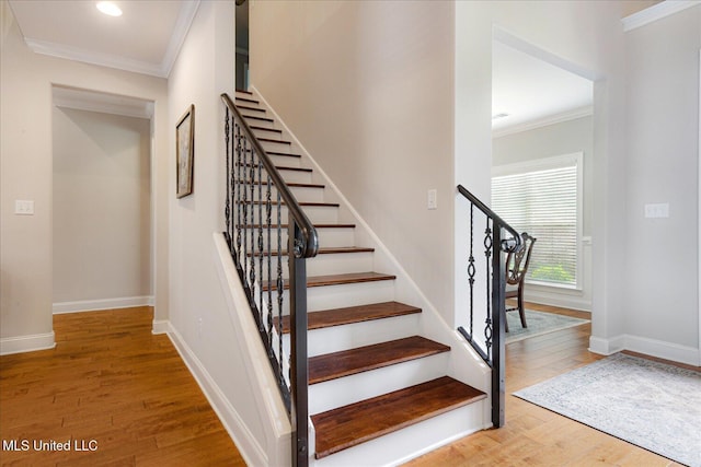 8063 Elizabeth Dr, Olive Branch, MS 38654 - stairway with ornamental molding, wood finished floors, baseboards, and recessed lighting