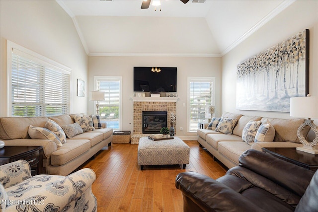 8063 Elizabeth Dr, Olive Branch, MS 38654 - living area featuring vaulted ceiling, a ceiling fan, light wood-type flooring, and a fireplace